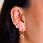 model wearing earring stack including the Labradorite & Diamond Huggie Hoop Earring 9k Gold