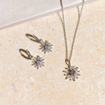 Jewelry set with star-shaped pendant on a beige surface