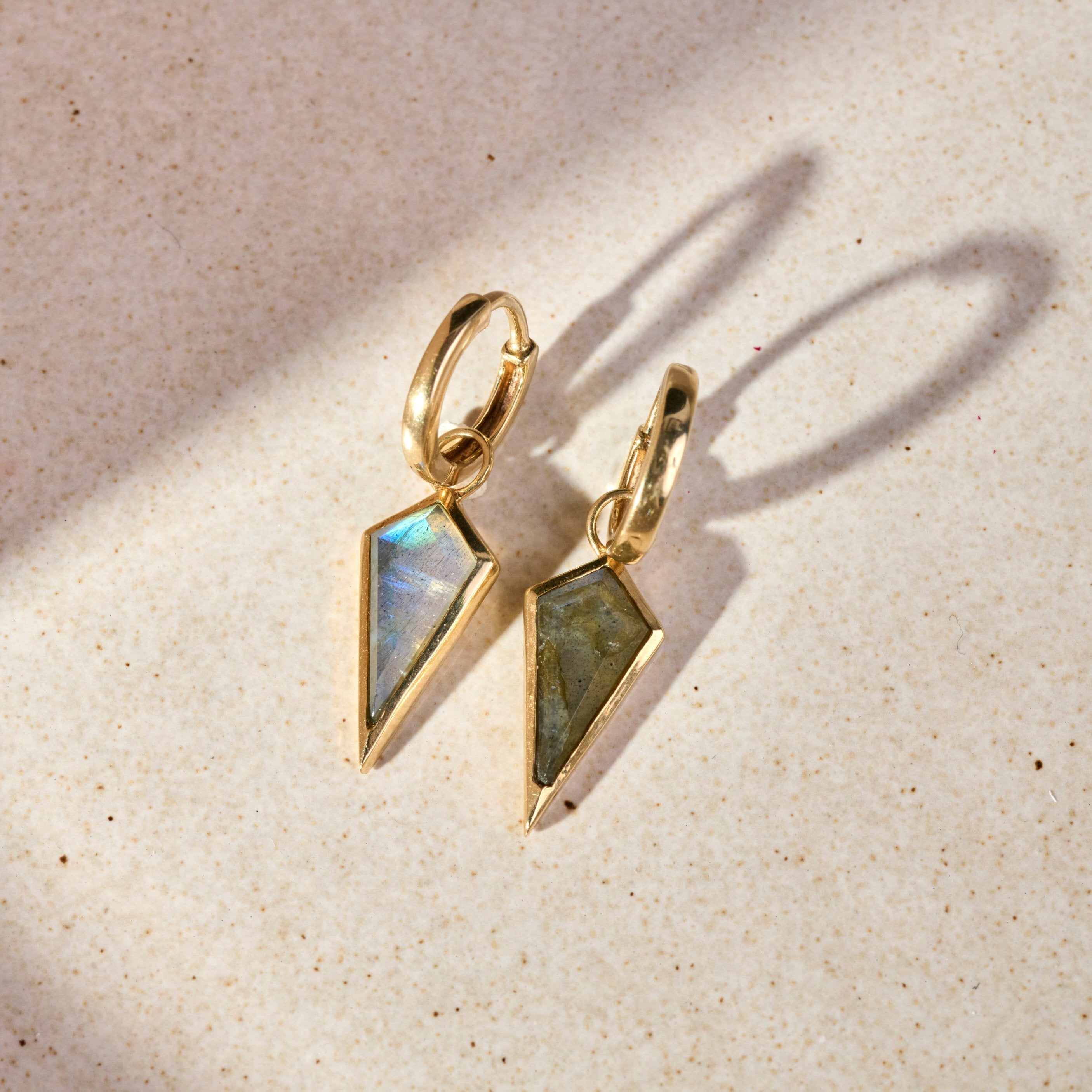 Labradorite Rhombus Earrings 9k Gold on hard surface