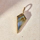 close up of the Labradorite Rhombus Pendant 9k Gold on hard surface