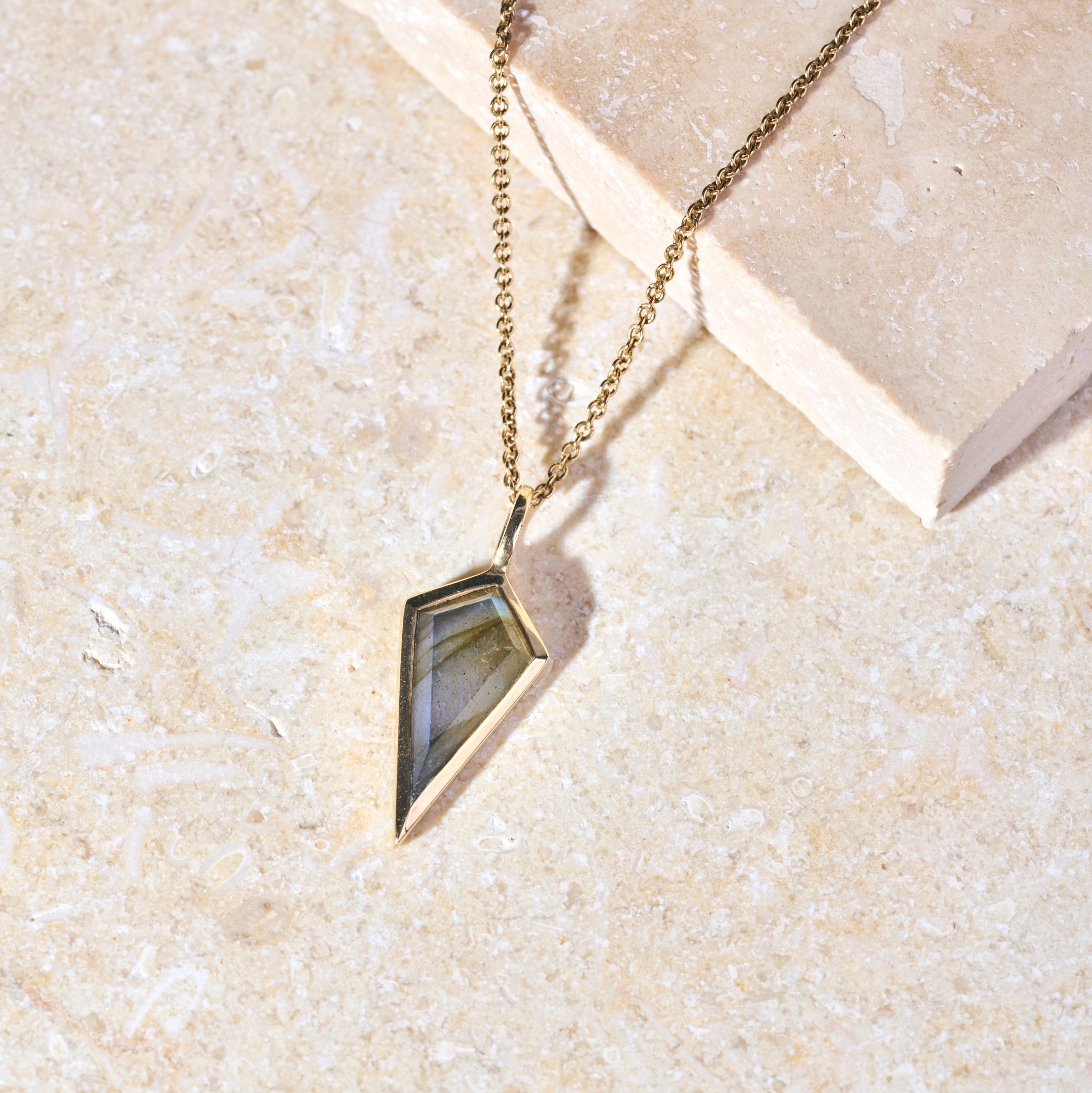 Labradorite Rhombus necklace 9k Gold on marble surface