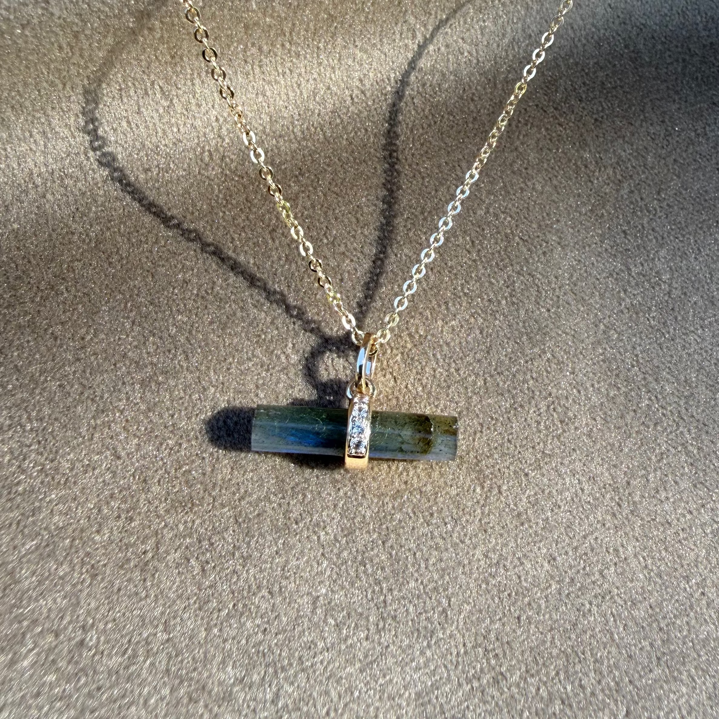 Labradorite T-Bar Necklace 9k Gold displayed on soft faric