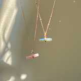 Labradorite T-Bar Pendant 9k Gold and guava quartz pendant dispayed