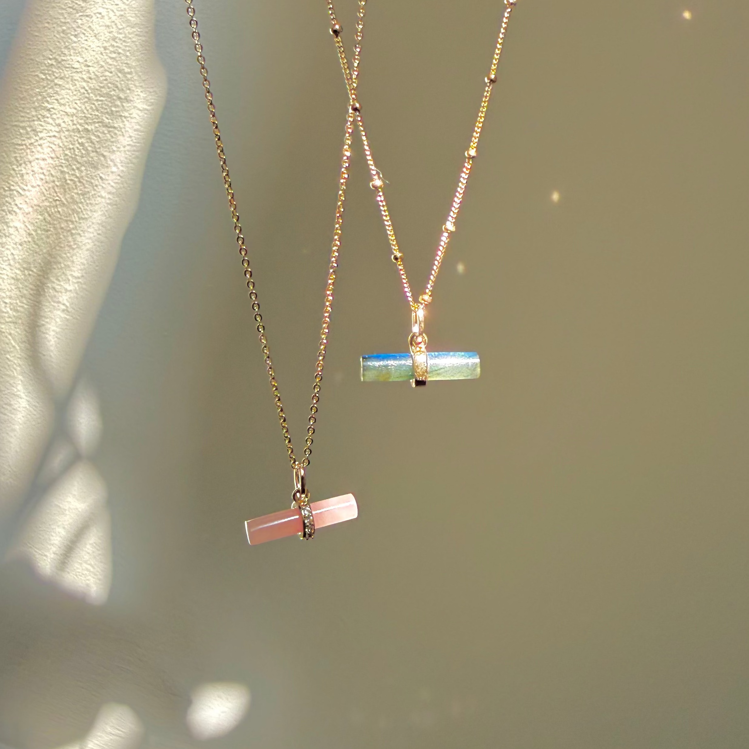 Labradorite T-Bar Pendant 9k Gold and guava quartz pendant dispayed