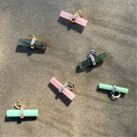 t-bar pendants in solid gold and sterling silver displayed on soft surface, including the Labradorite T-Bar Pendant 9k Gold