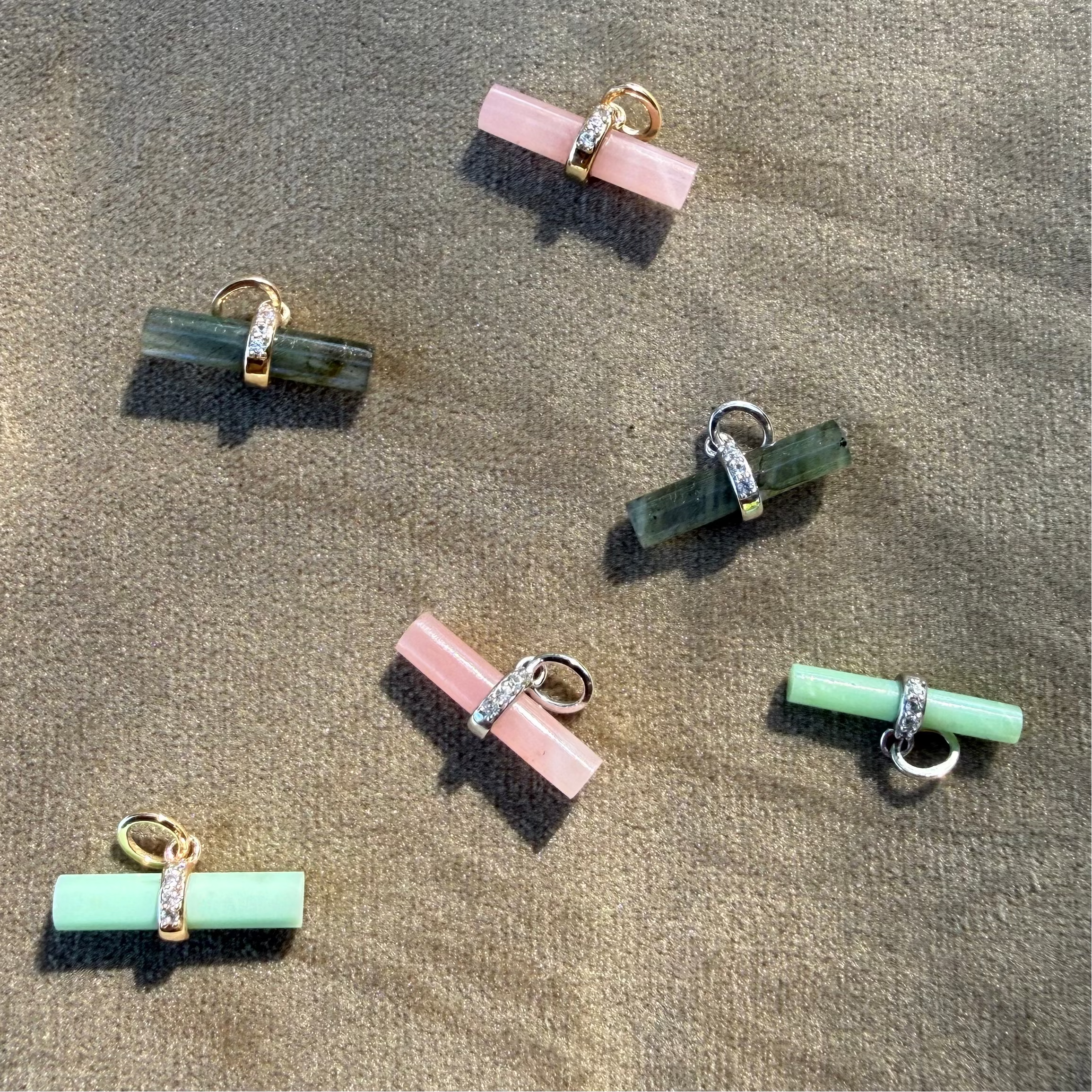 t-bar pendants in solid gold and sterling silver displayed on soft surface, including the Labradorite T-Bar Pendant 9k Gold