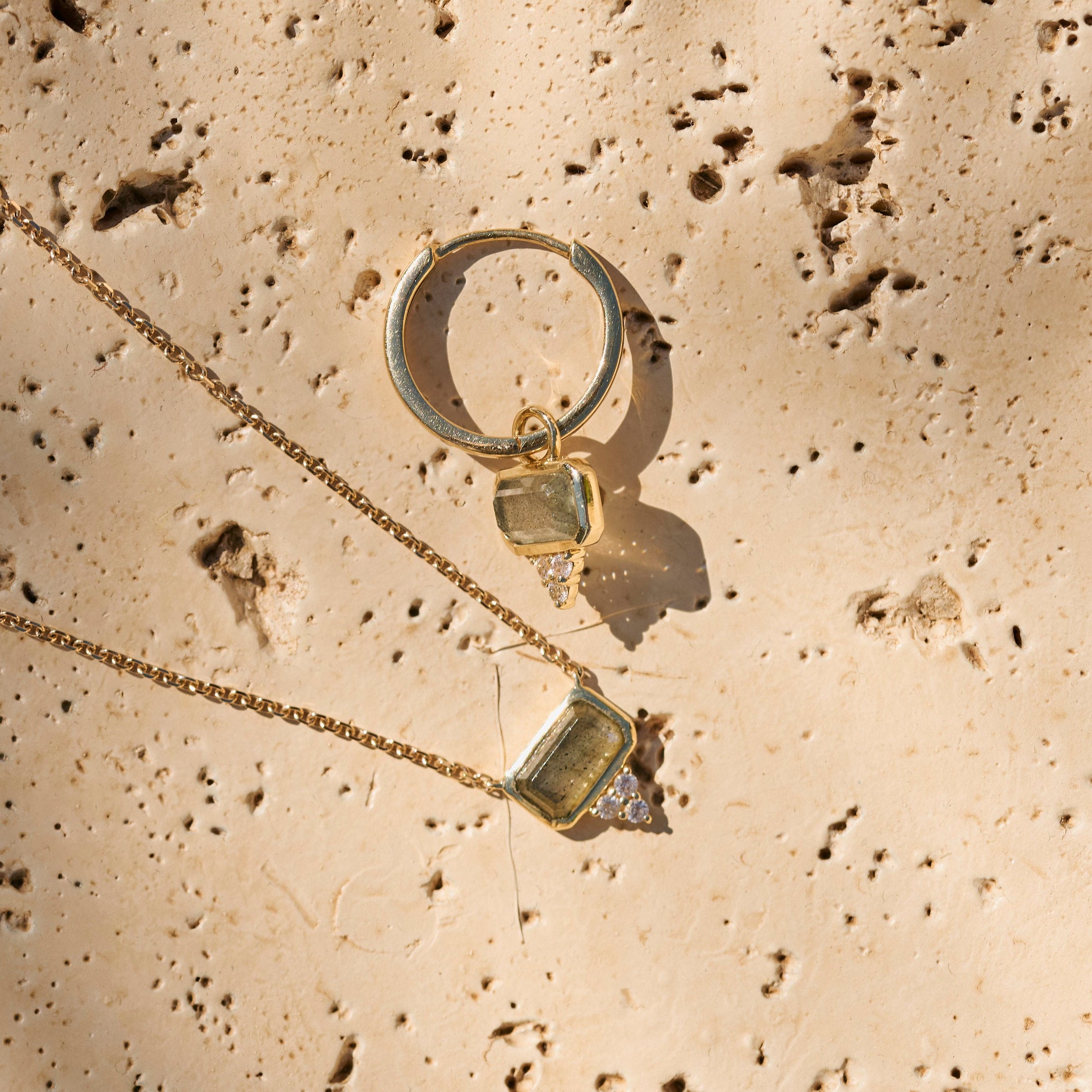Labradorite & White Sapphire Necklace 9k Gold on hard surface with matching hoop earring
