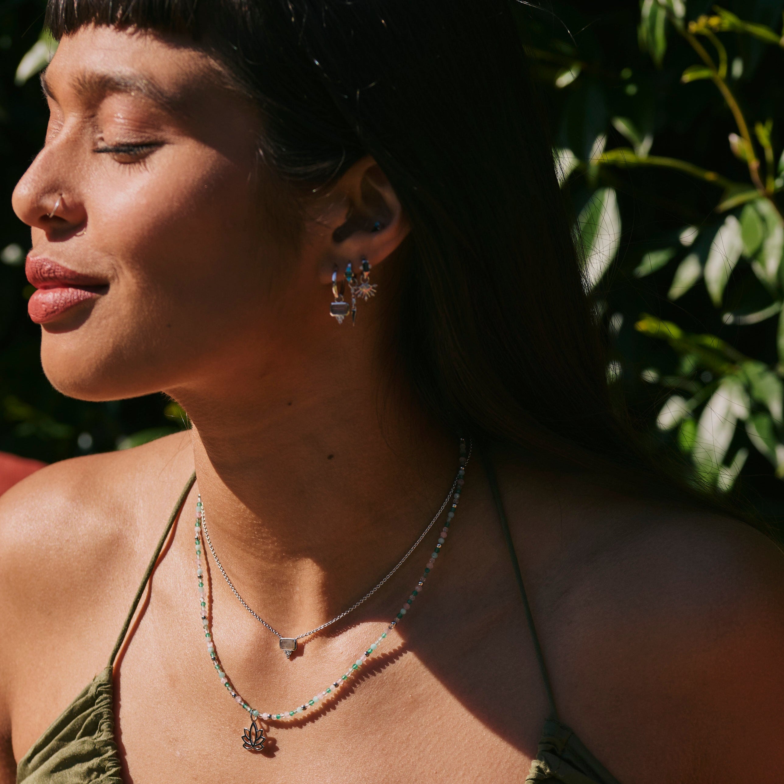 model wearing the Labradorite & White Sapphire Necklace Sterling Silver and beaded necklace and lotus flower pendant