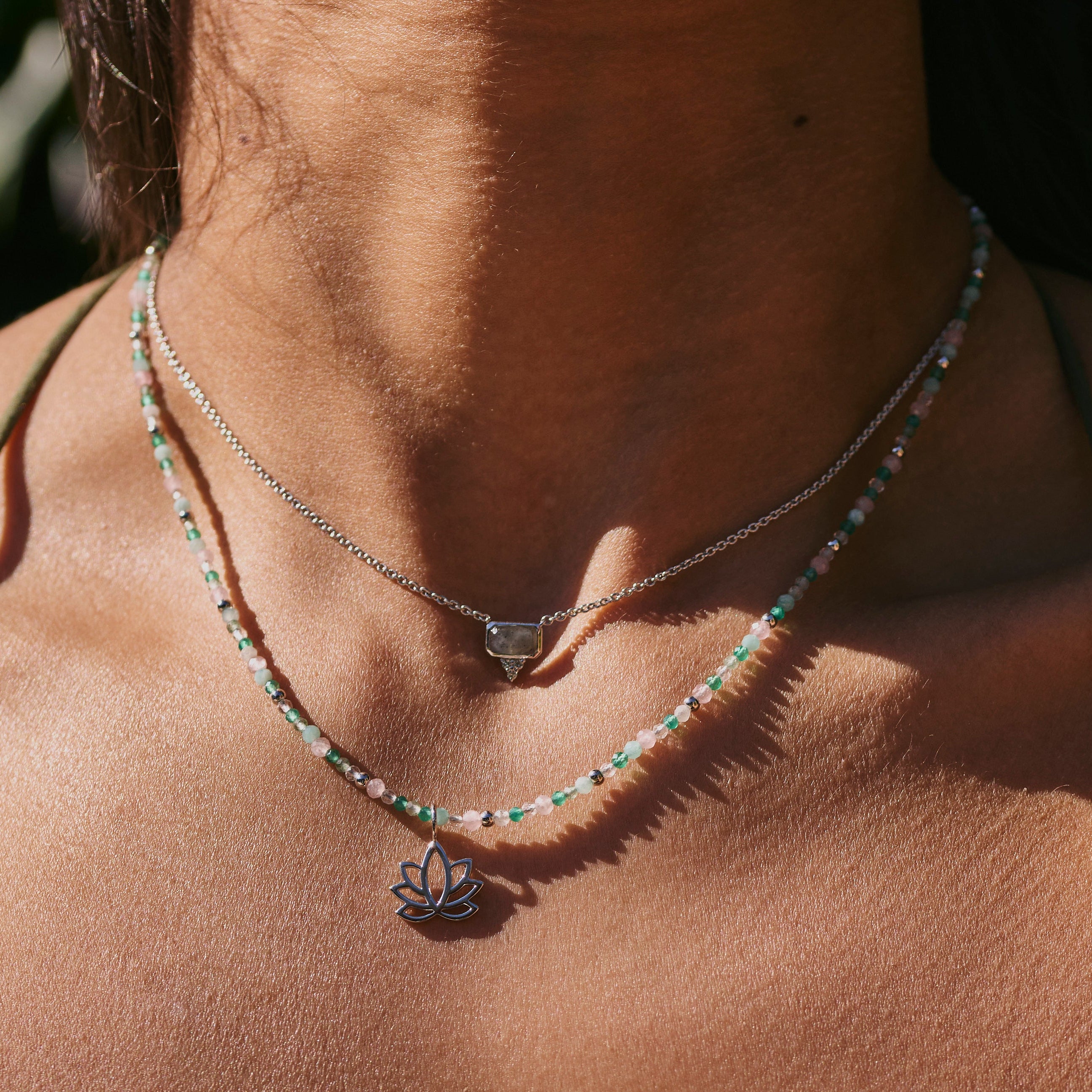 model wearing the Labradorite & White Sapphire Necklace Sterling Silver along with the beaded necklace and lotus pendant