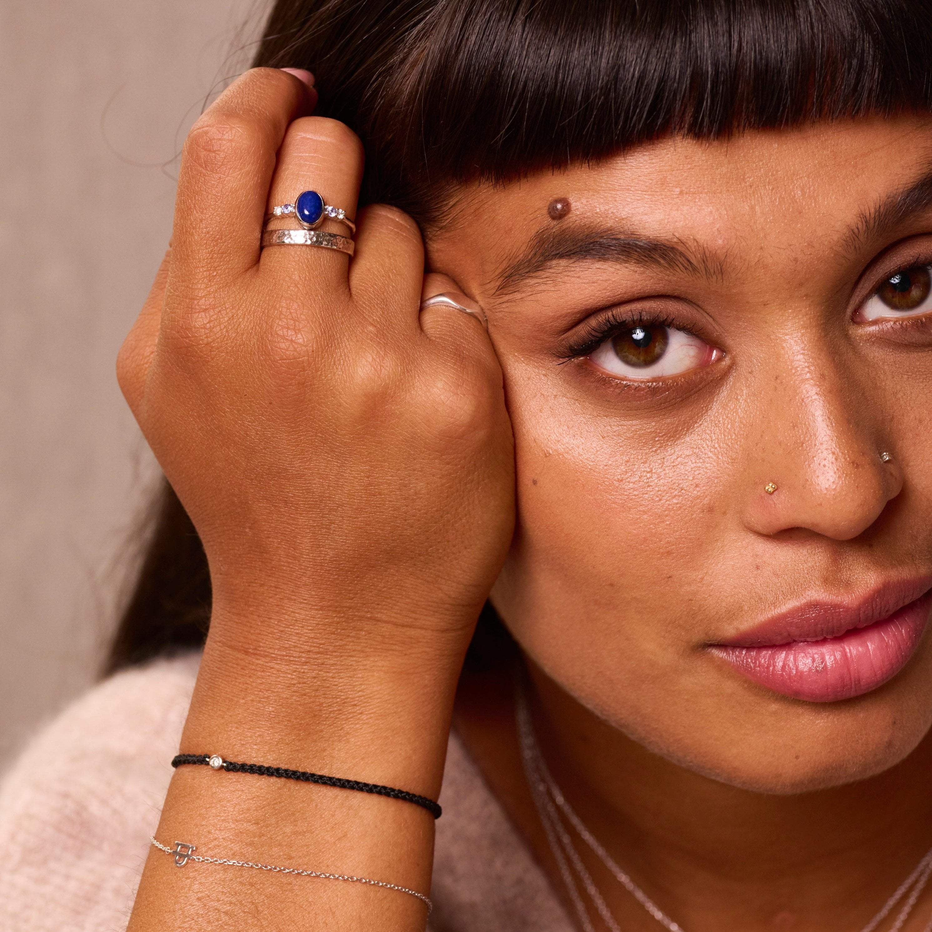 model wearing solid metal jewellery including the Lapis, Tanzanite & White Sapphire Ring Sterling Silver