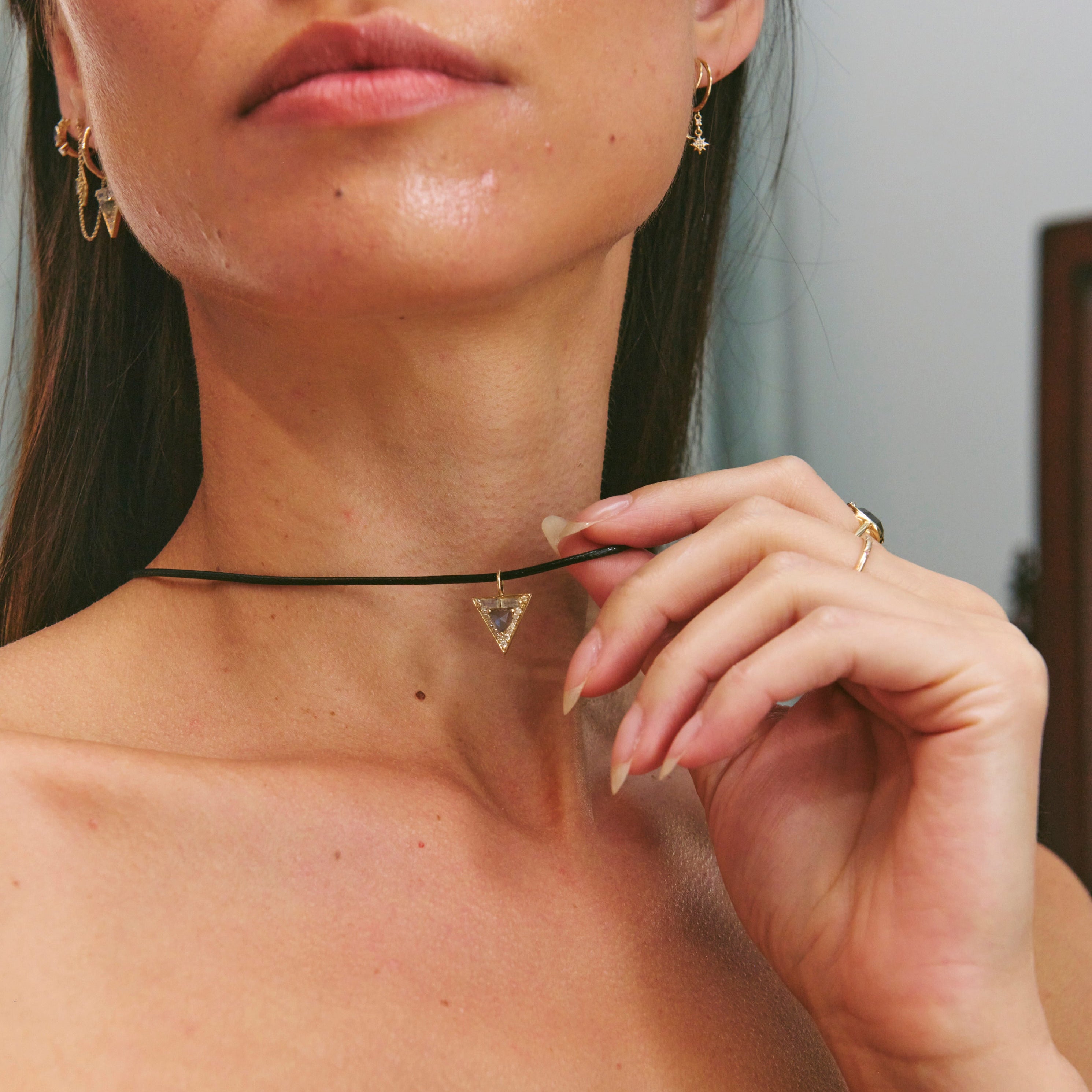 Woman wearing a choker necklace with a plain background