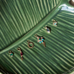 solid gold earring charms displayed on leaf dish including the Limited Edition Malachite Eye Earring Charm 9k Gold