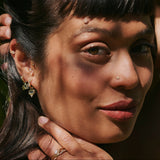 model wearing the Labradorite & White Sapphire Earring Charm 9k Gold along with other solid gold pieces