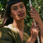 model wearing the Lotus Flower Pendant 9k Gold along with other solid gold jewellery