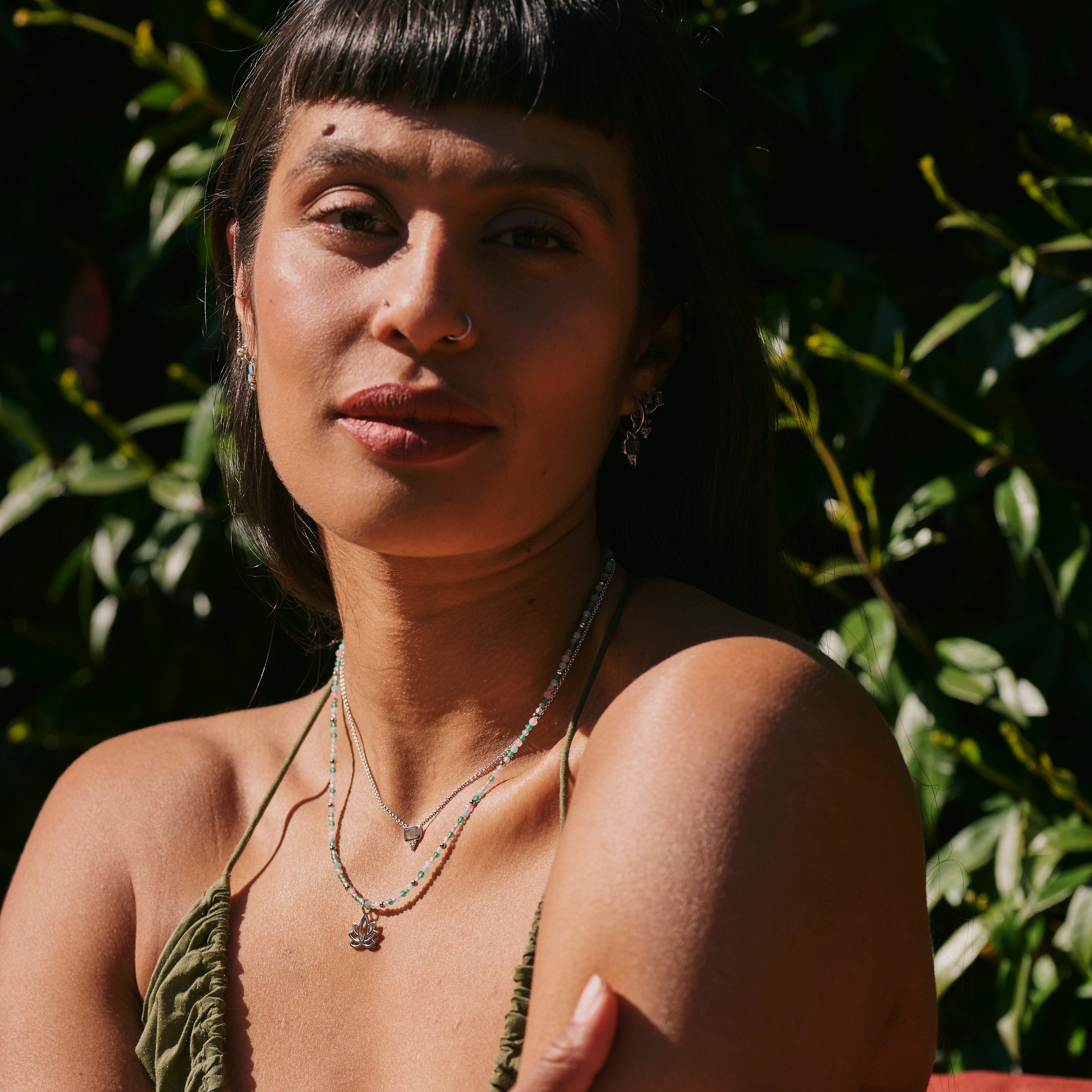 model wearing the Lotus Flower Pendant Sterling Silver along with other sterling silver pieces