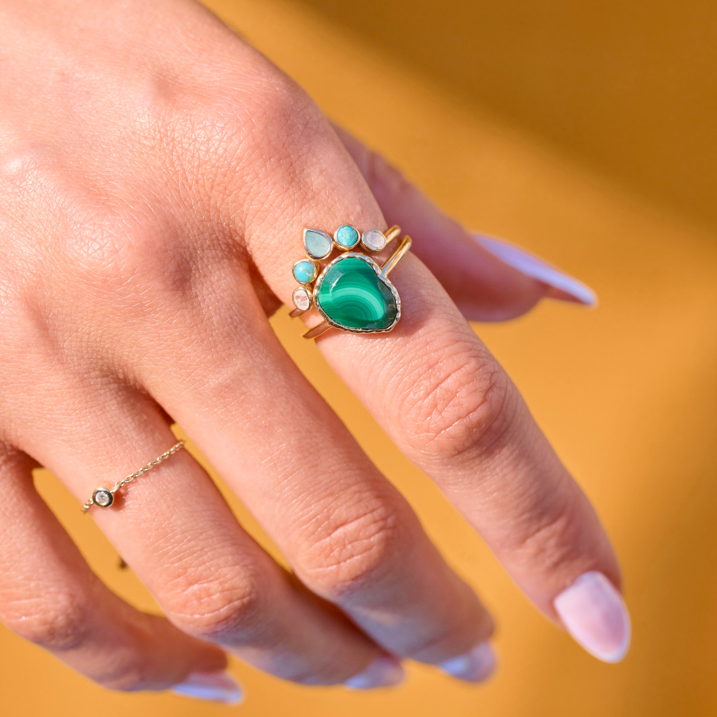 solid gold gemstone rings on model