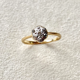 close up of the Mini Diamond Star Engraved Vintage Ring on  hard surface