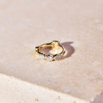 Mini Diamond Trilogy Huggie Hoop Earring 9k Gold on  hard surface