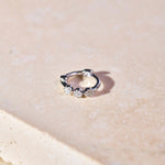 Mini Diamond Trilogy Huggie Hoop Earring Sterling Silver on hard surface