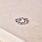 Mini Diamond Trilogy Huggie Hoop Earring Sterling Silver on hard surface