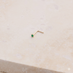 Mini Emerald Nose Stud 9k Gold on marble