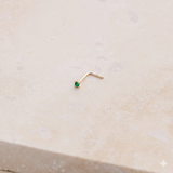 Mini Emerald Nose Stud 9k Gold on marble
