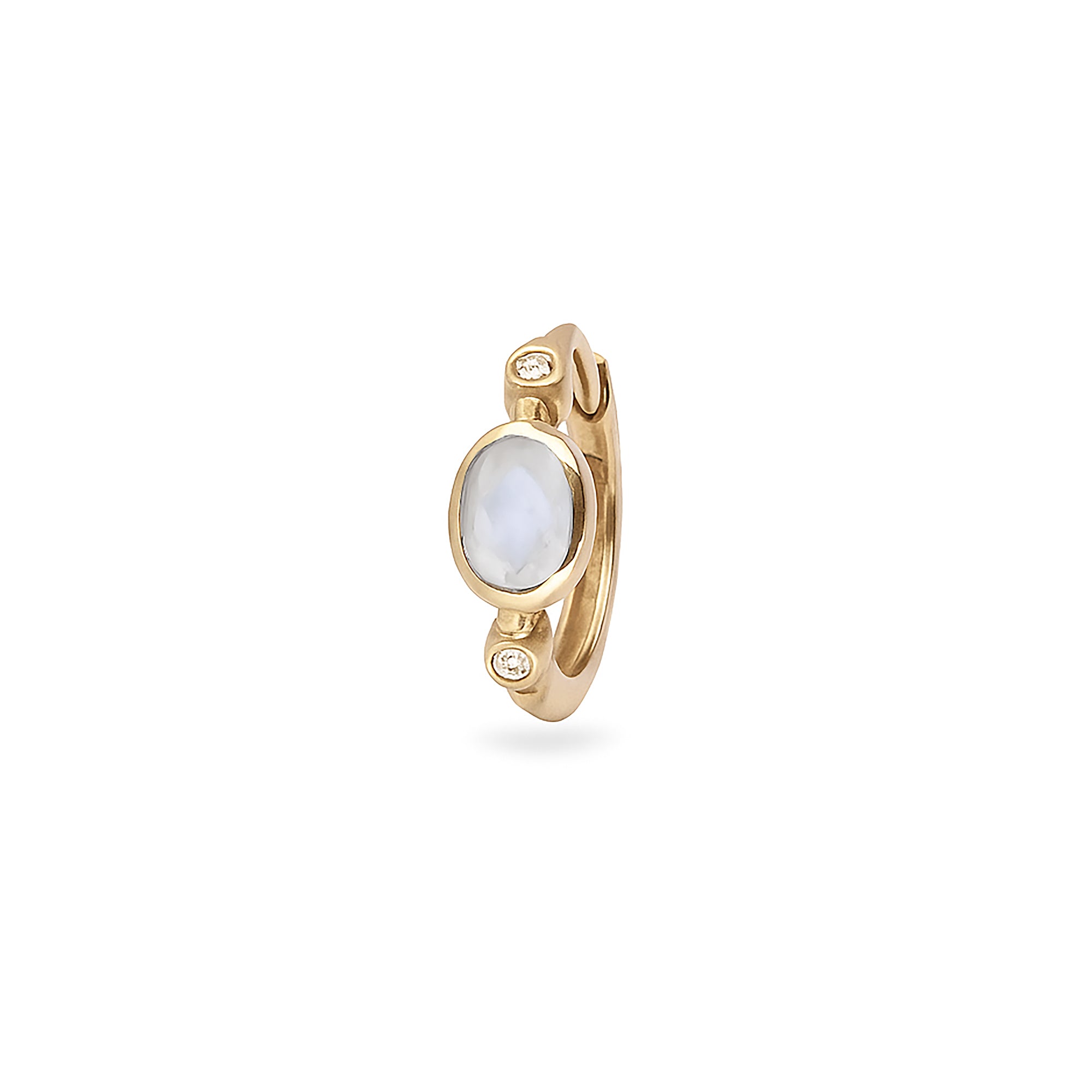 Gold earring with a white gemstone on a white background