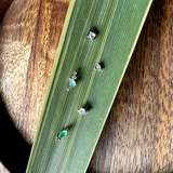 Small decorative stones on a green leaf with a wooden background