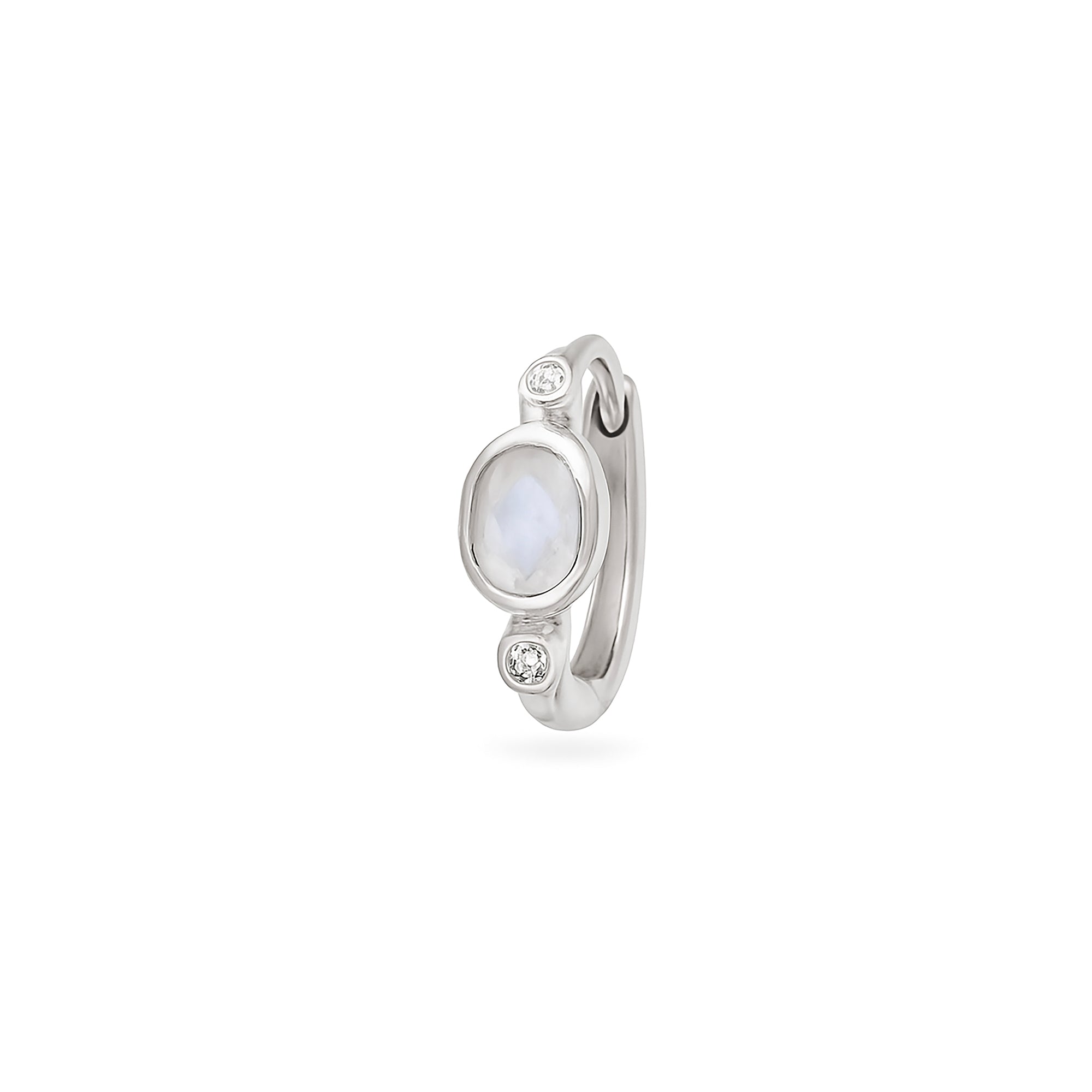 Silver huggie with a central gemstone and smaller stones on a white background