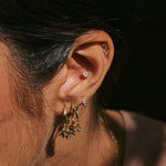 model wearing solid gold ear stack including the Moonstone Trillion & Diamond Flat Back Earring 9k Gold