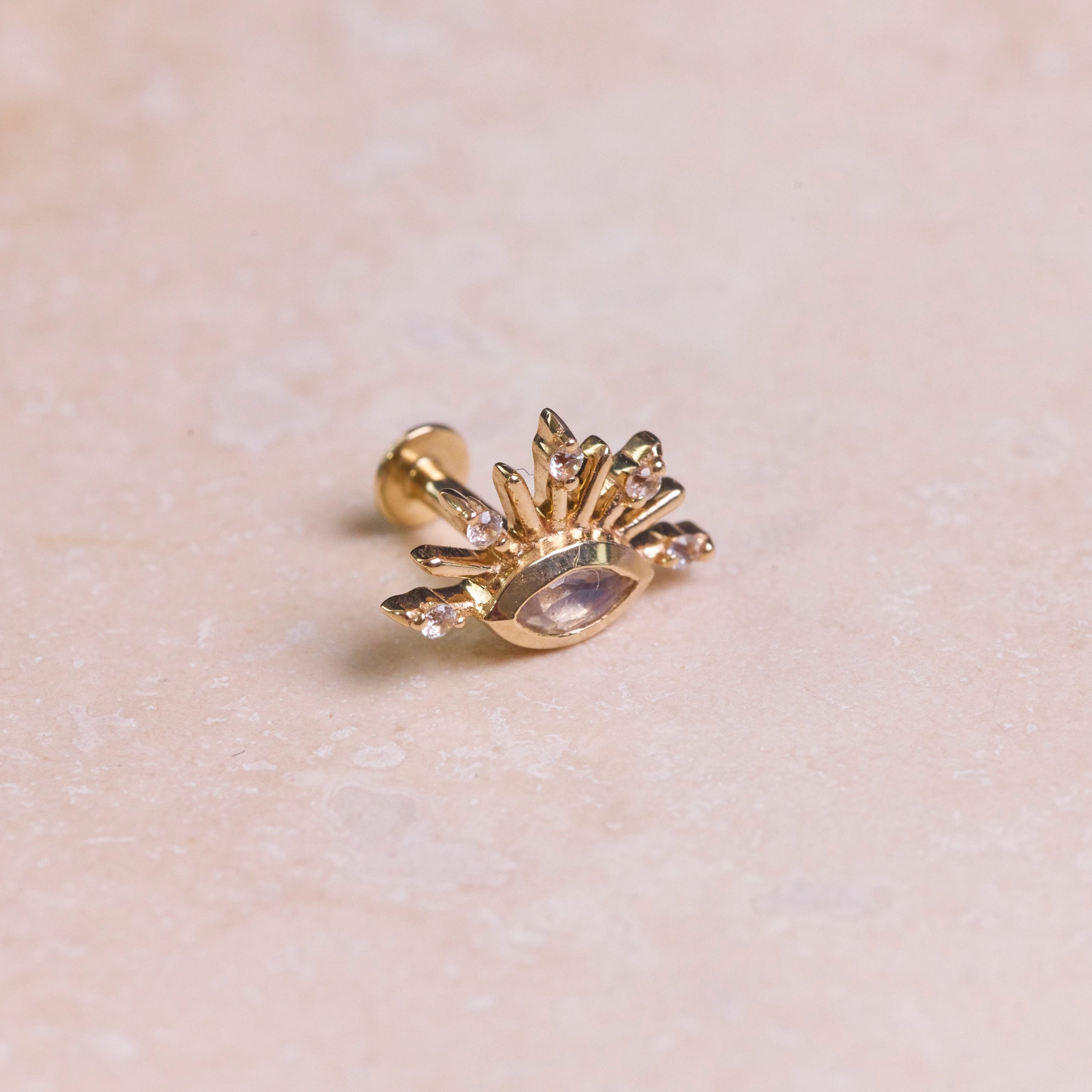 Moonstone & White Sapphire Sunburst Flat Back Earring 9k Gold on the side on hard surface