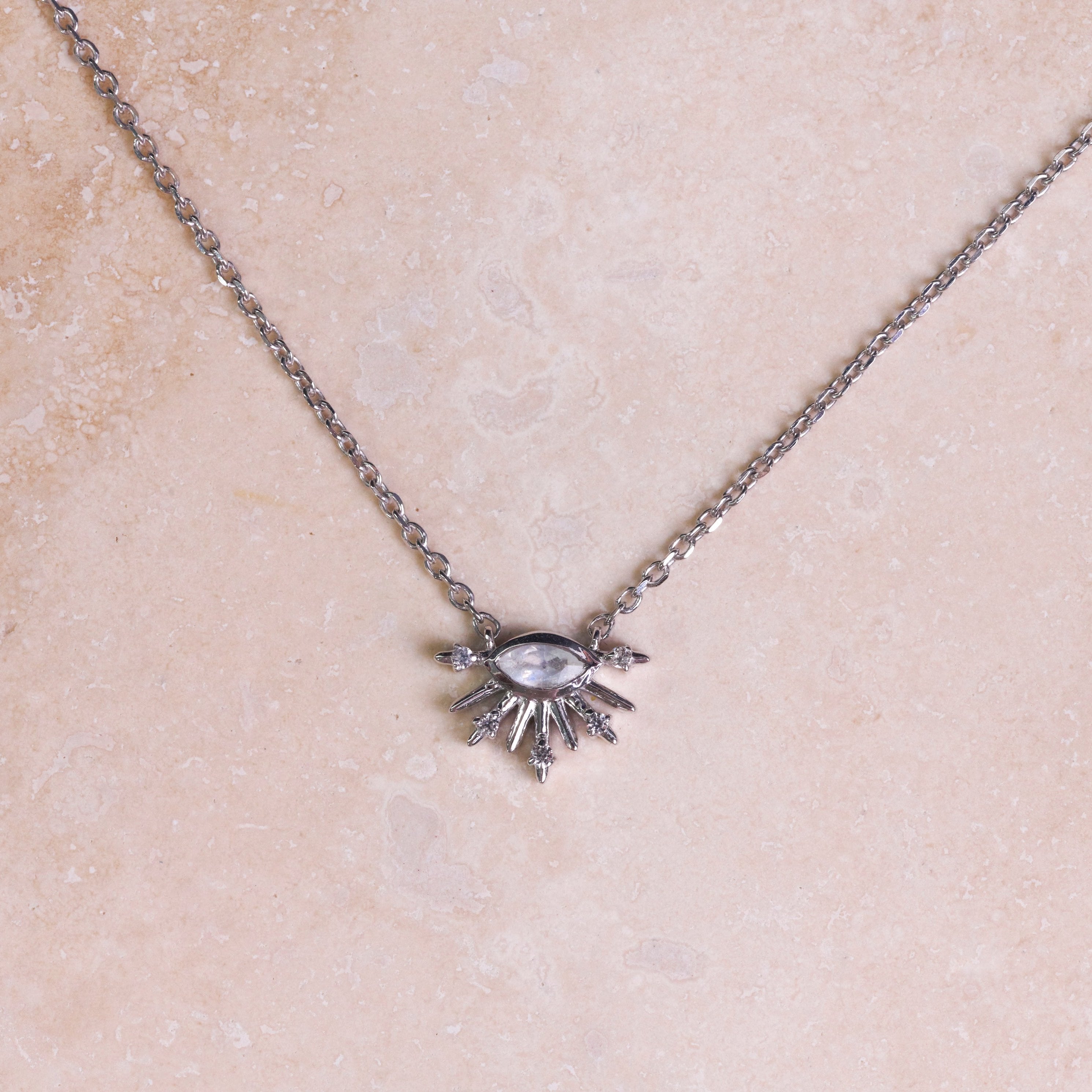 Moonstone & White Sapphire Sunburst Necklace Sterling Silver on hard surface