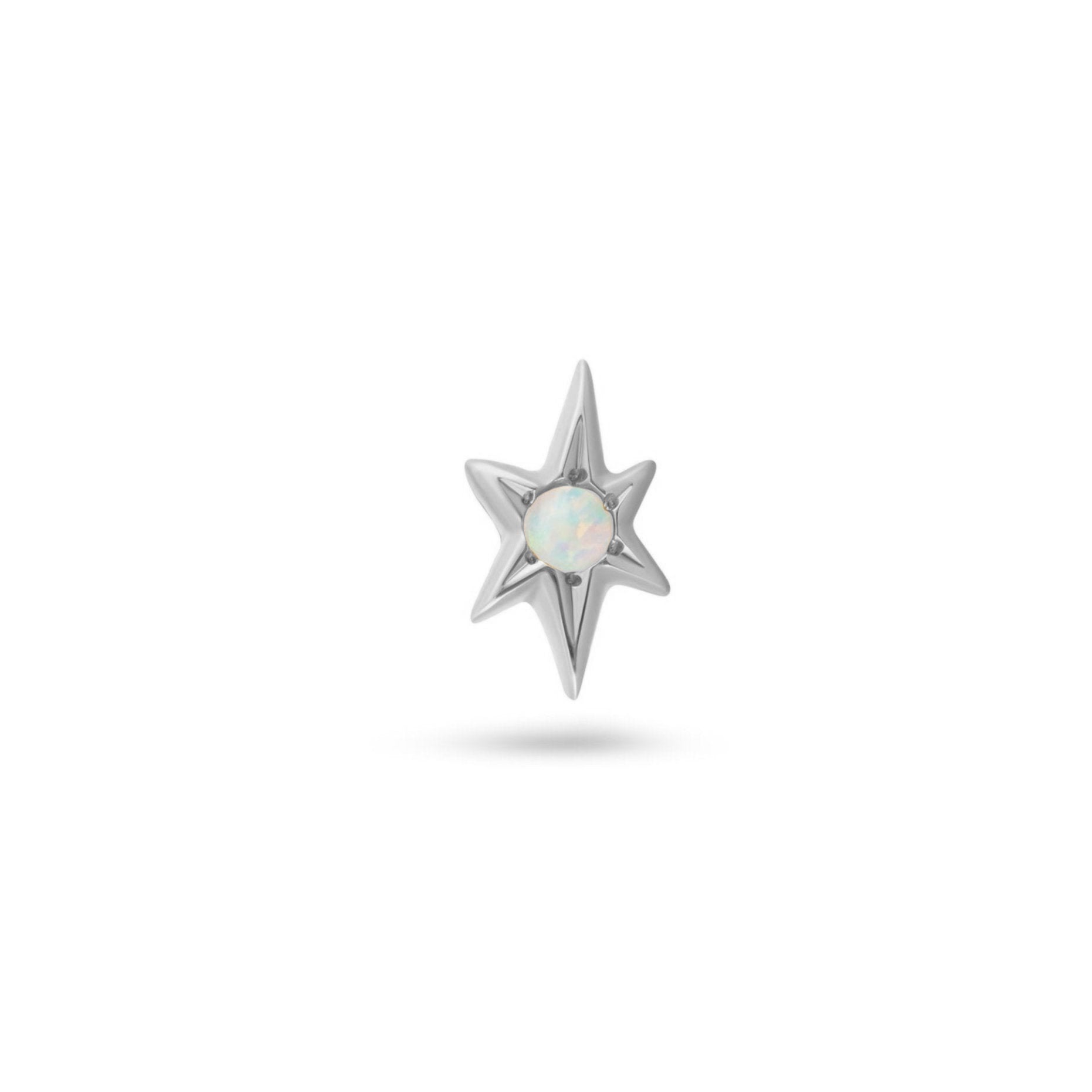 white gold star-shaped earring with a central gemstone on a white background