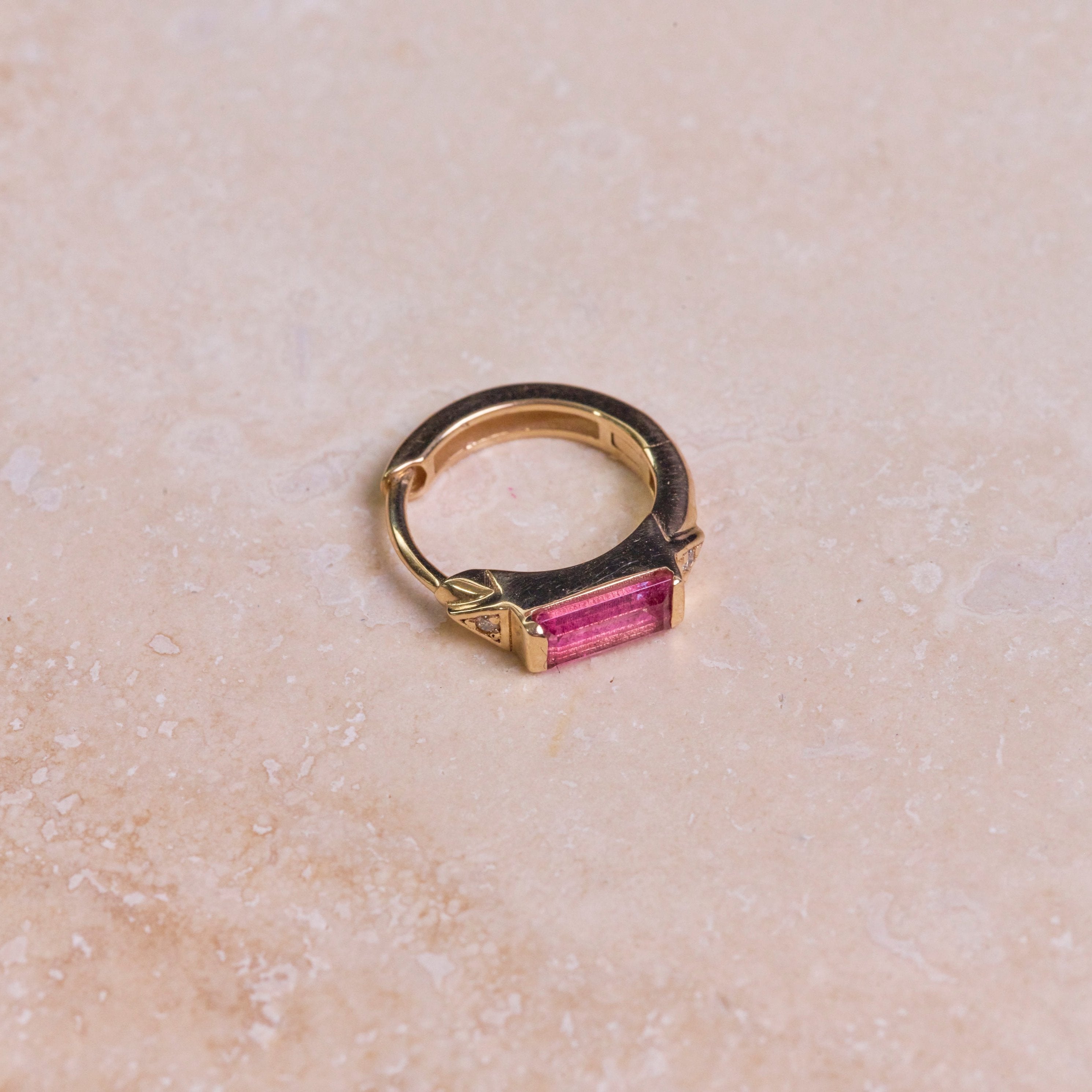 Pink Tourmaline & Diamond Huggie Hoop Earring 9k Gold on hard surface