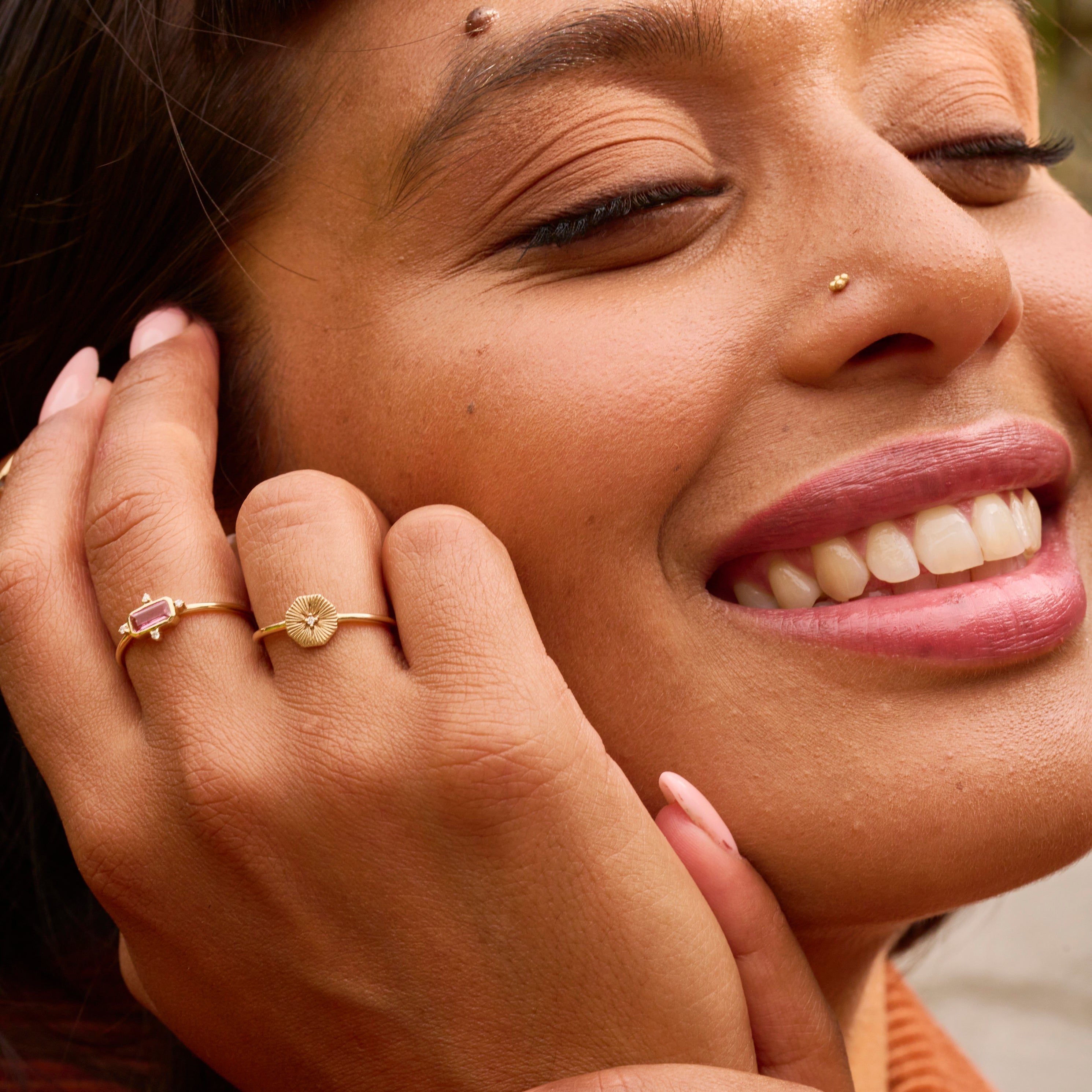 model wearing solid gold rings including the Pink Tourmaline & Diamond Ring 9k Gold