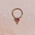 Pink Tourmaline, Diamond & Topaz Daith Hoop 9k Gold on marble surface