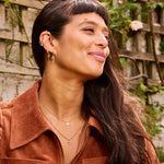 model wearing solid gold jewellery including the Pink Tourmaline, Diamond & Moonstone Pendant 9k Gold