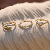 Raindrop Ring 9k Gold displayed with the snake ring and scattered diamond band ring