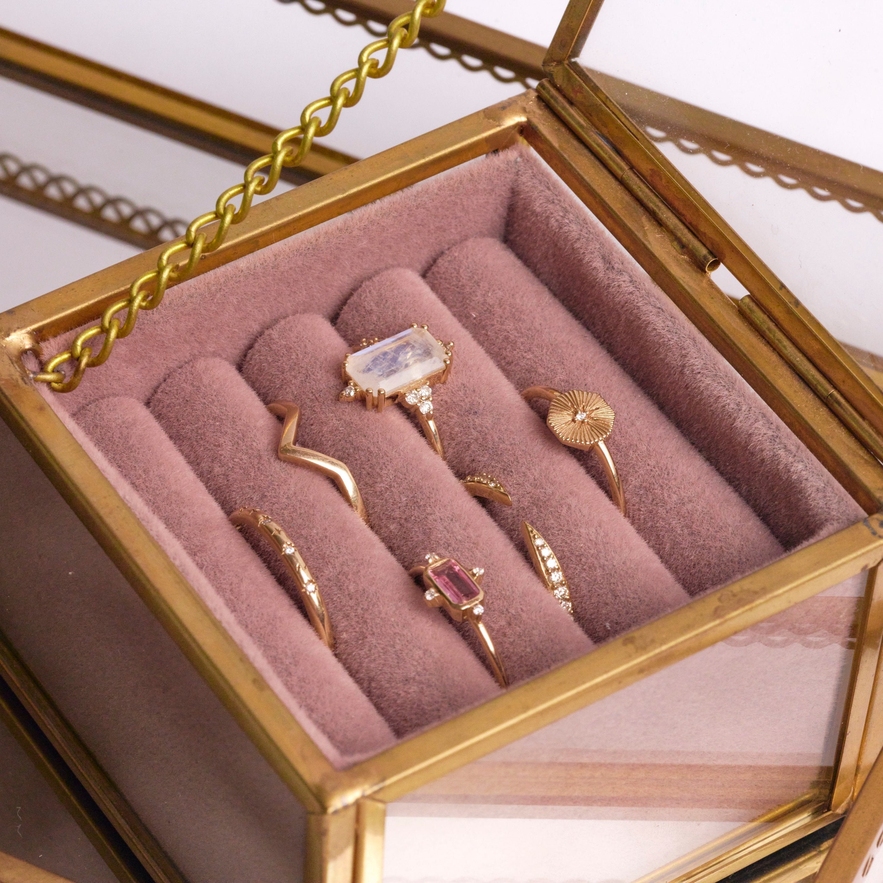 solid gold rings in fabric jewellery box including the Rectangle Moonstone & Diamond Ring 9k Gold