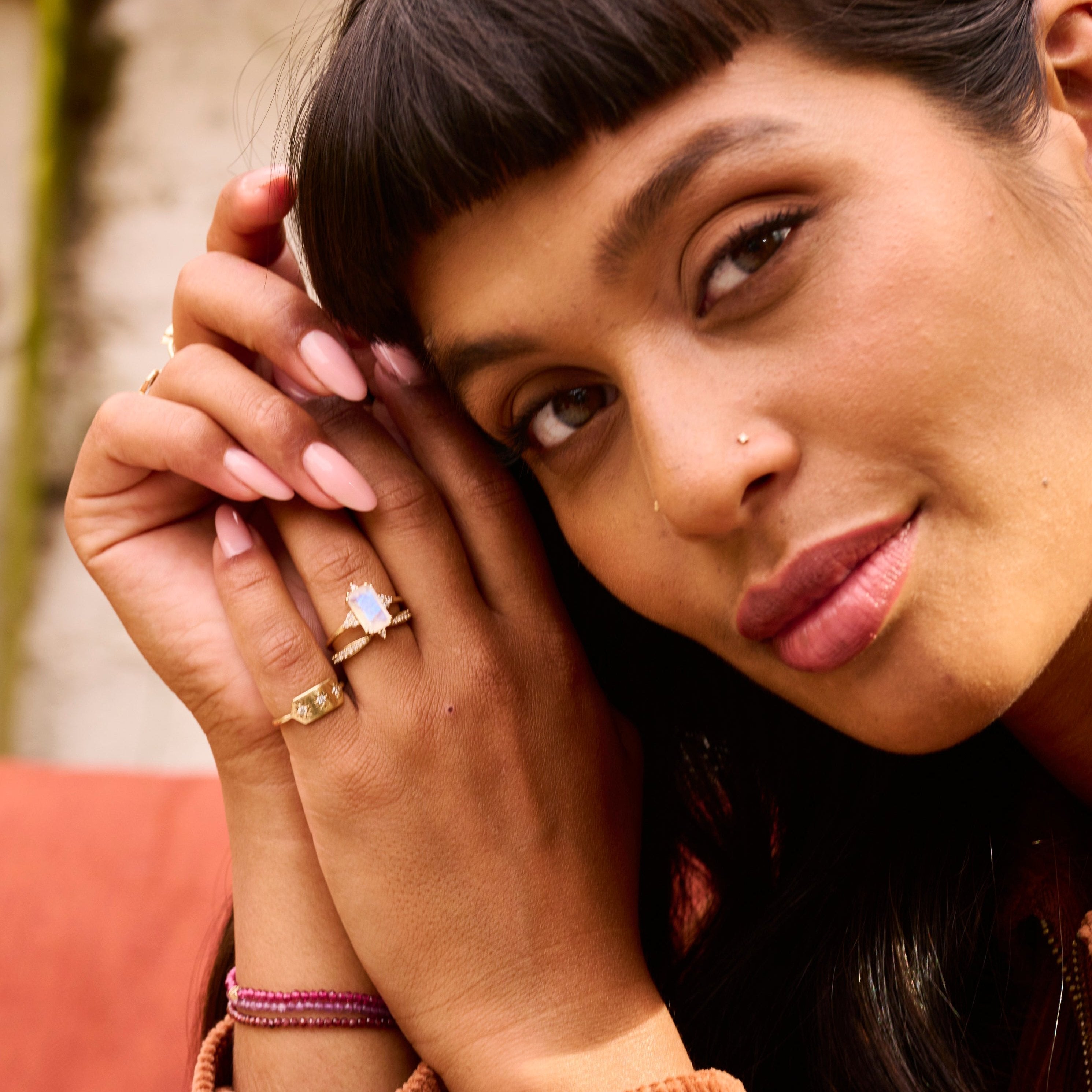 model wearing solid gold rings including the Rectangle Moonstone & Diamond Ring 9k Gold