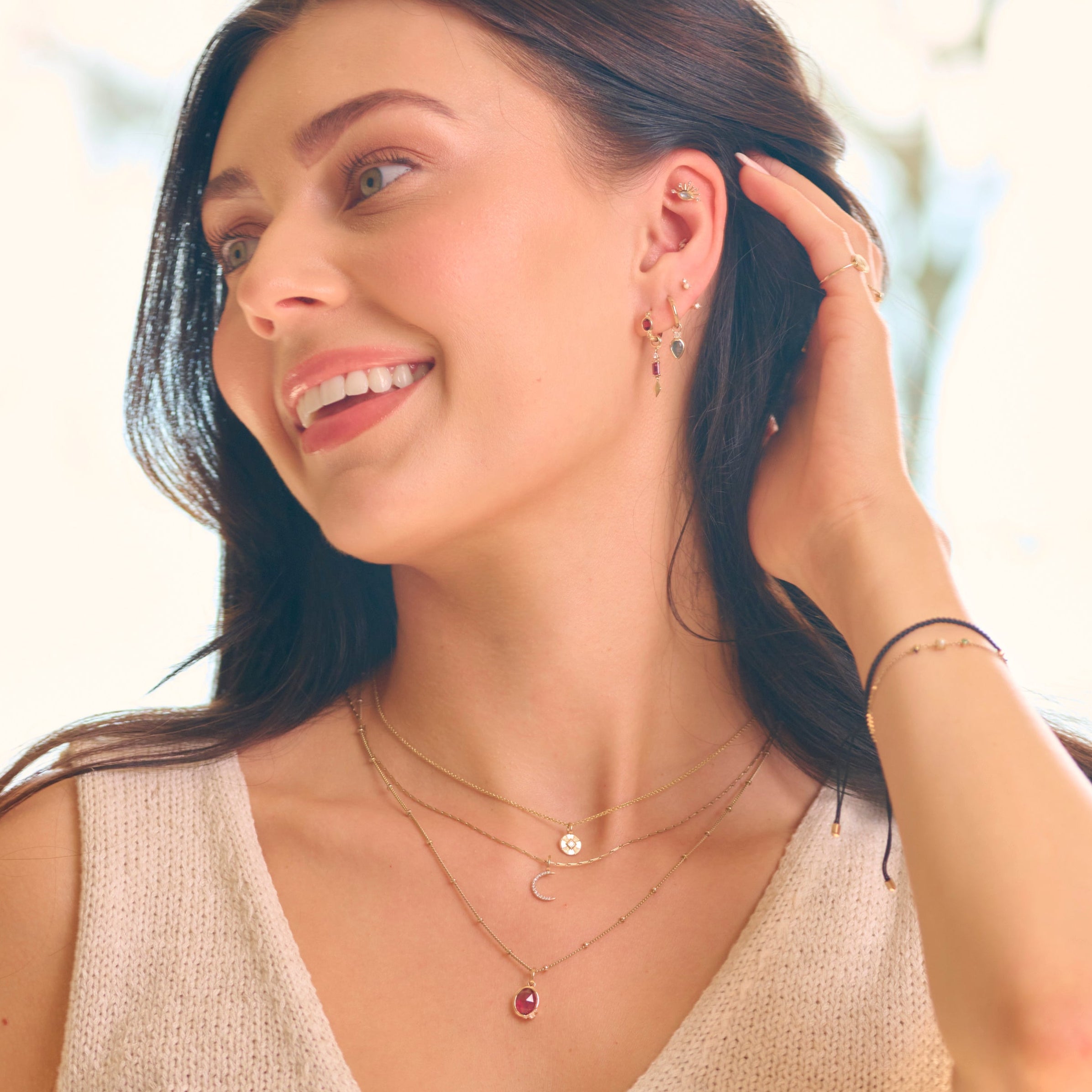 model wearing solid gold pieces including the Rhodolite Garnet & Diamond Earring Charm 9k Gold

