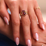 model hand wearing solid gold rings including the Rhodolite Garnet, Moonstone & White Sapphire Ring 9k Gold