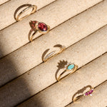 solid gold rings in tray including the Rhodolite Garnet, Moonstone & White Sapphire Ring 9k Gold
