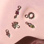 sterling silver earring charms displayed on hard surface including the Rhodolite Garnet & White Sapphire Earring Charm Sterling Silver