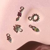 sterling silver earring charms displayed on hard surface including the Rhodolite Garnet & White Sapphire Earring Charm Sterling Silver