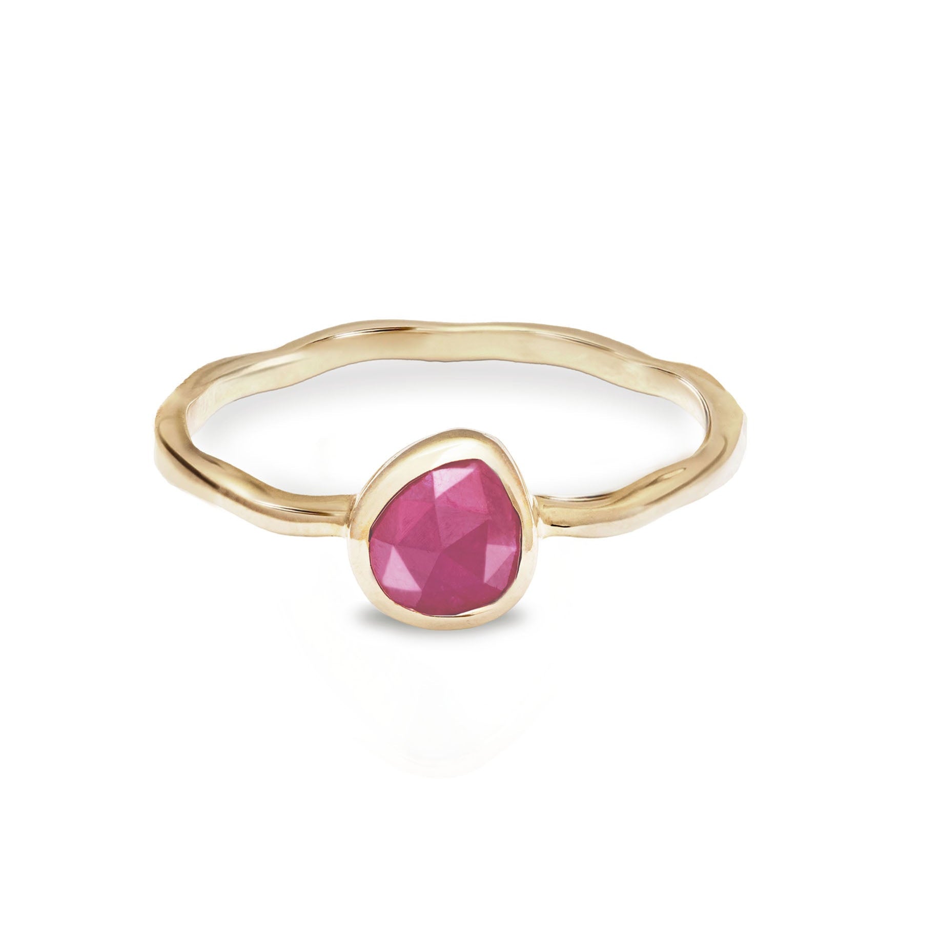 Gold ring with a pink gemstone on a white background