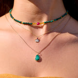 gold necklaces with beaded necklace on model