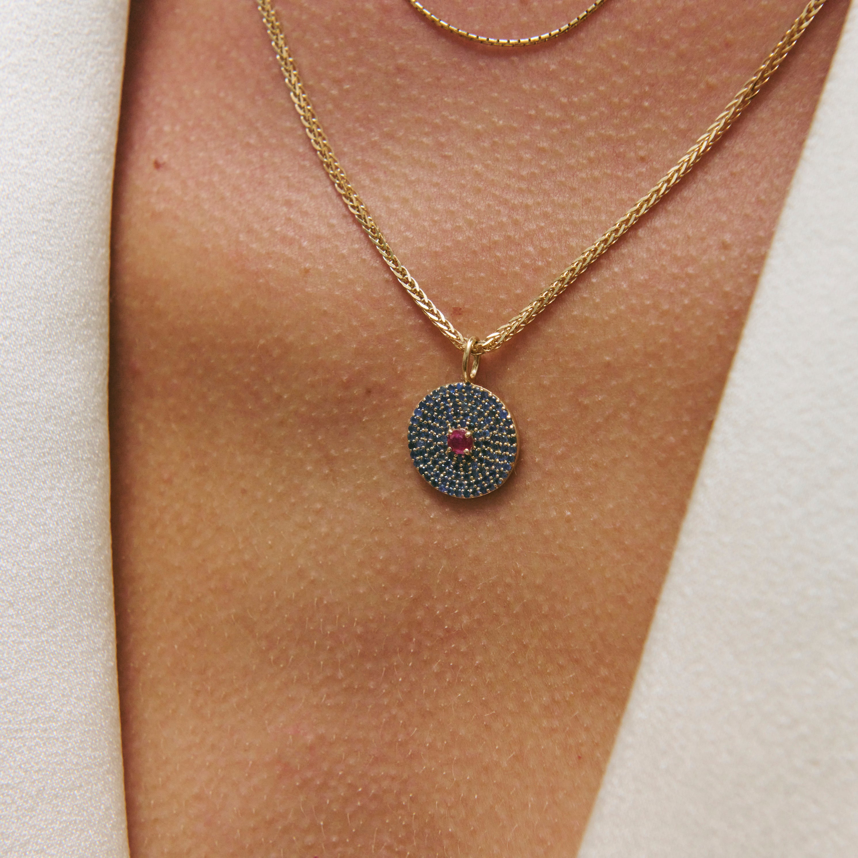 Sapphire & Ruby 9k gold pendant on model