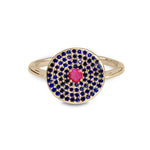 Gold ring with blue and pink gemstones on a white background