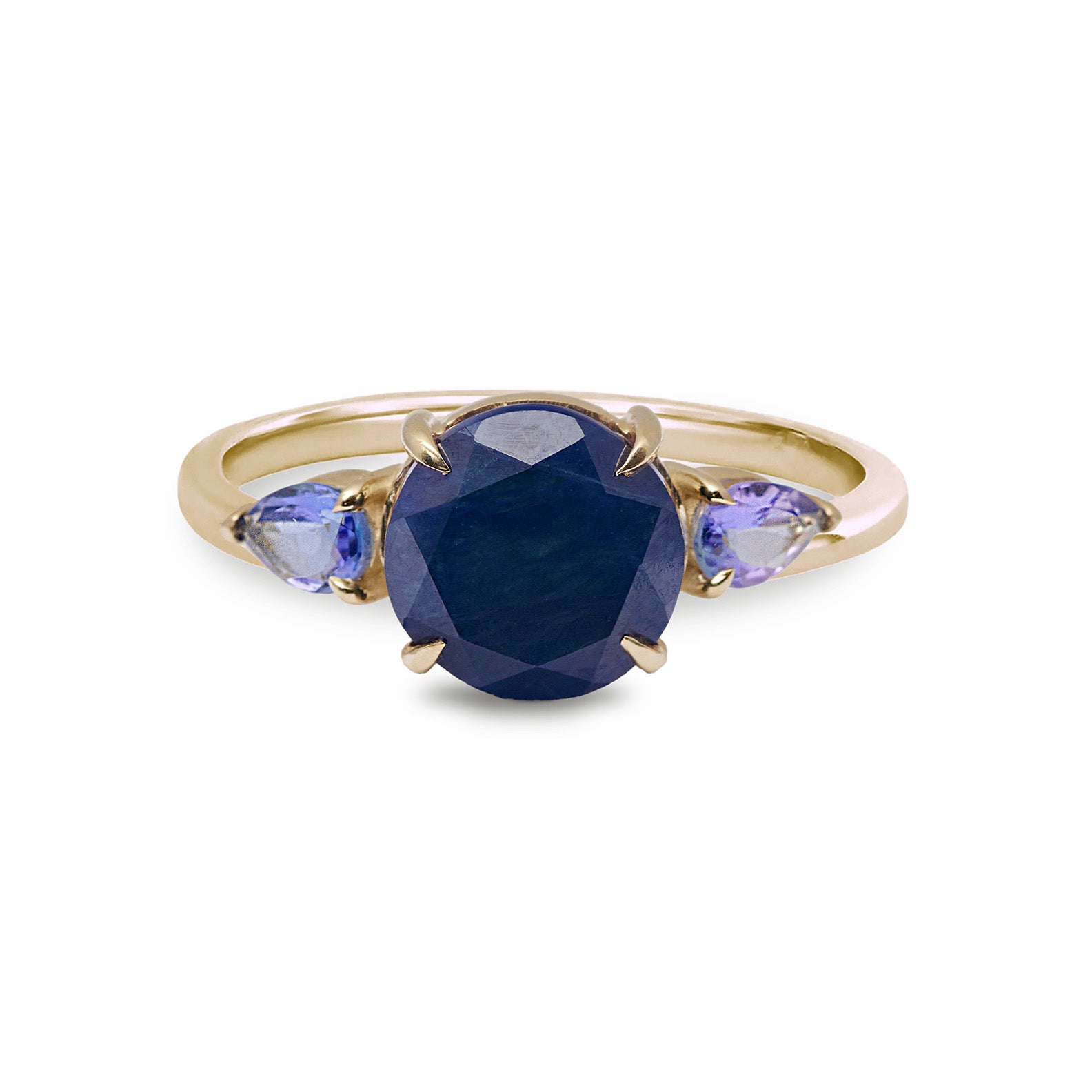 Gold ring with a blue gemstone and smaller purple stones on a white background